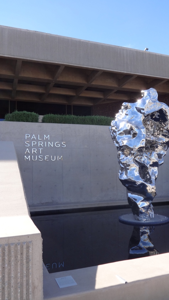 The sculpture captures the feel of a waterfall, in metal, which seems apt for a desert setting