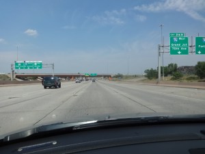 The two lane blacktop gives way to the concrete freeway and a familiar, crowded world: Denver, 30 miles to Boulder.